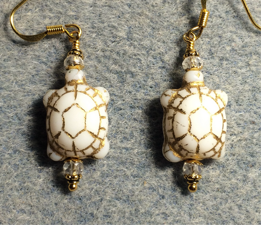 Opaque white (with gold inlay) Czech glass turtle bead earrings adorned with clear Chinese crystal beads.