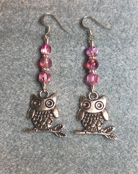 Silver owl charm earrings adorned with bright pink Czech glass beads.