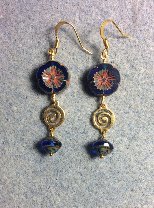 Cobalt blue Czech glass pansy bead earrings adorned with gold swirly connectors and cobalt blue Czech glass Saturn beads.