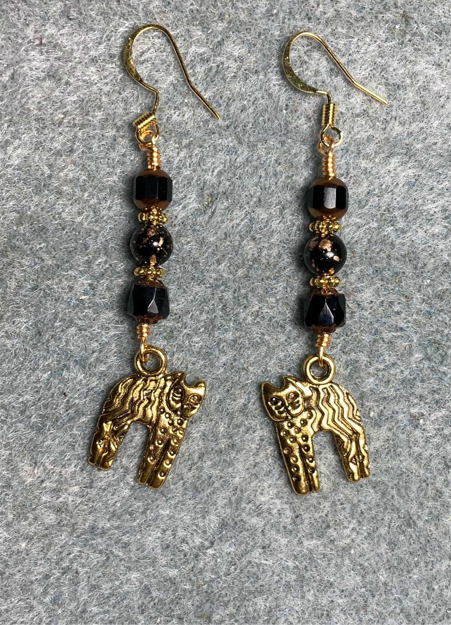 Gold cat charm earrings adorned with black Czech glass beads