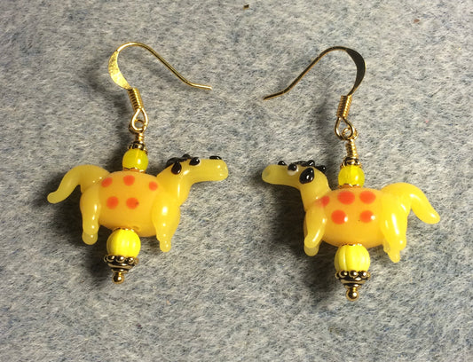 Opaque golden yellow and red lamp work spotted horse bead earrings adorned with yellow Czech glass beads.