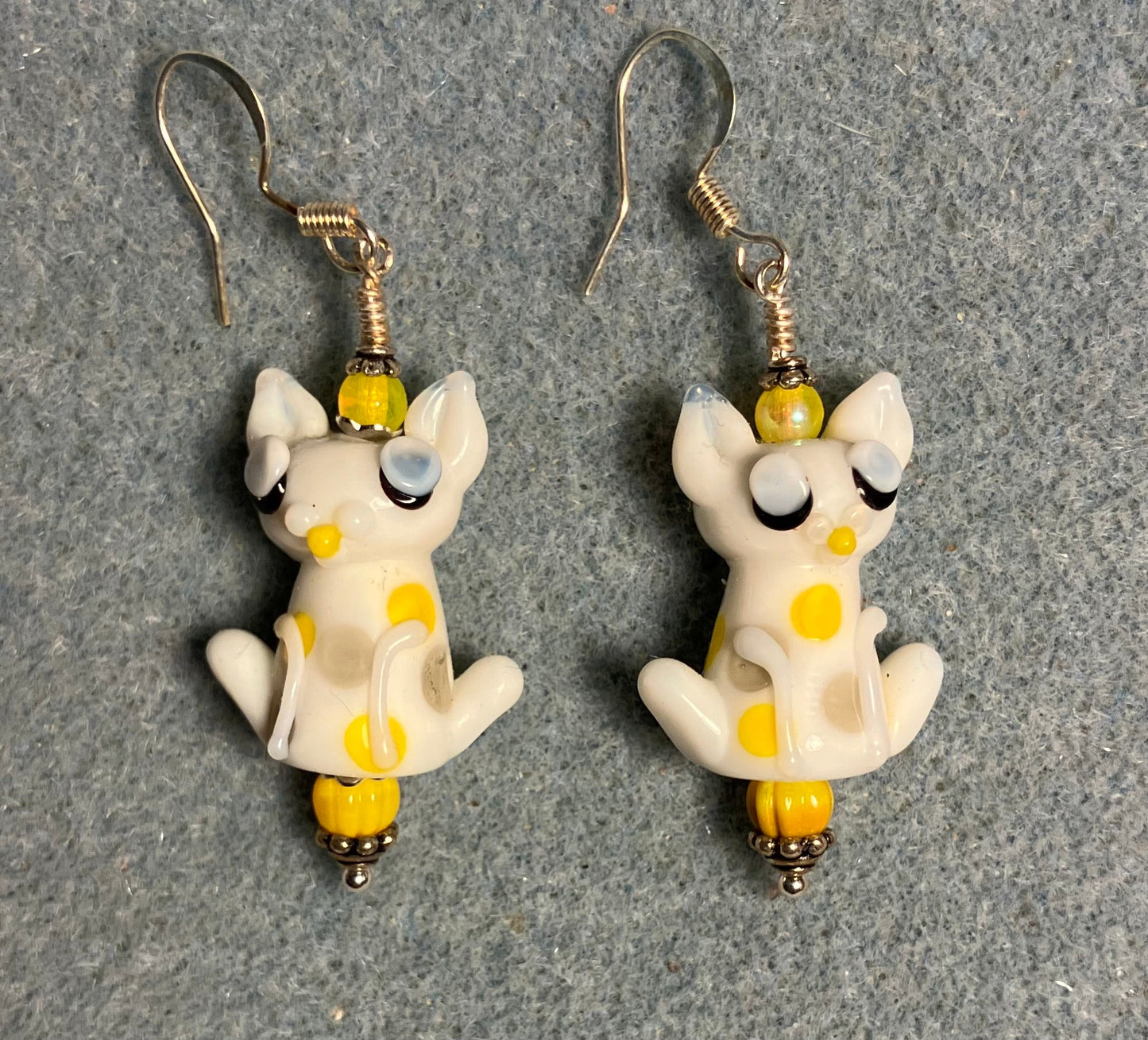 White and yellow lamp work cat bead earrings adorned with yellow Czech glass beads.