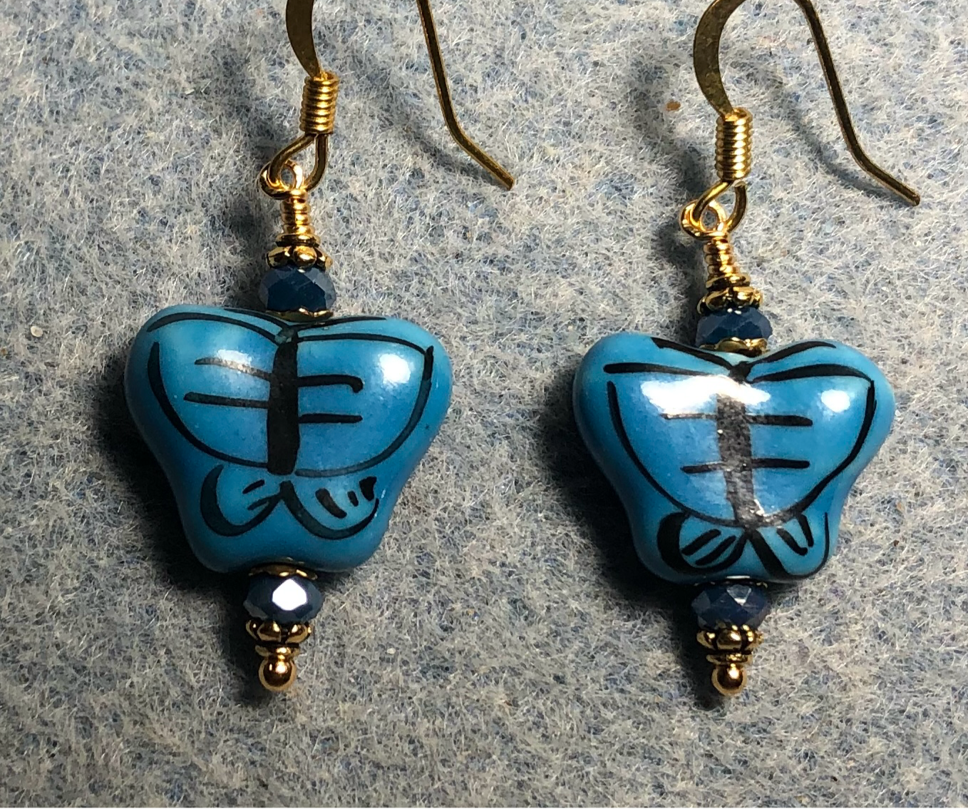 Bright blue ceramic butterfly bead earrings adorned with blue Chinese crystal beads.