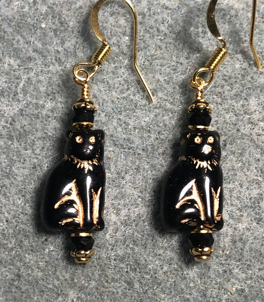 Small shimmery black and gold Czech glass cat bead earrings adorned with black Chinese crystal beads.