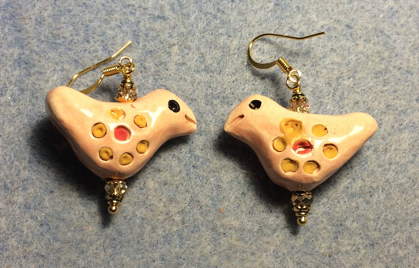 Medium peach, yellow, and red ceramic songbird bead earrings adorned with rose gold Chinese crystal beads.