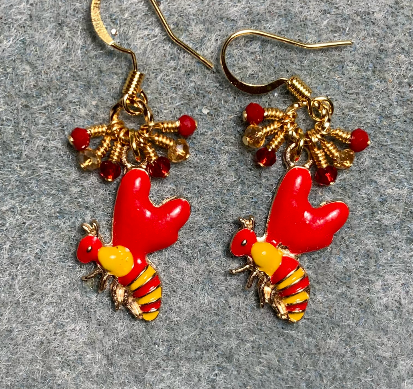 Bright red and golden yellow enamel striped honeybee charm earrings adorned with tiny dangling red and topaz Chinese crystal beads.