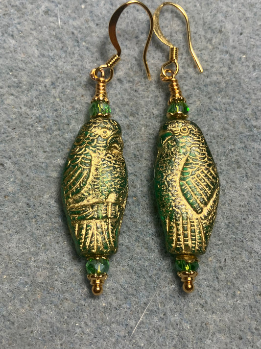 Large green teal (with gold wash) Czech glass parrot bead earrings adorned with green Chinese crystal beads.
