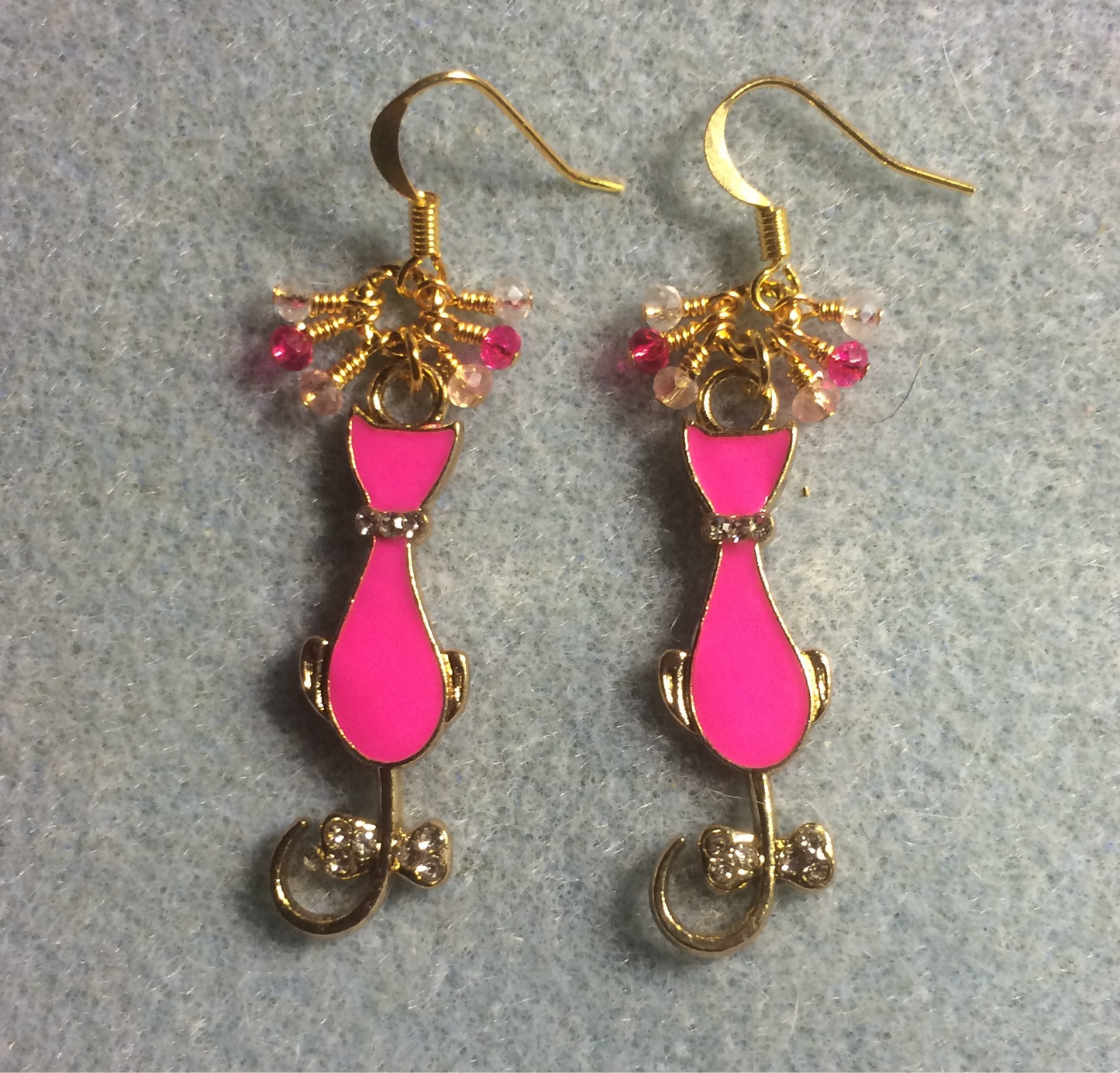 Hot pink and gold enamel cat charm earrings adorned with tiny dangling hot pink and gold Chinese crystal beads.
