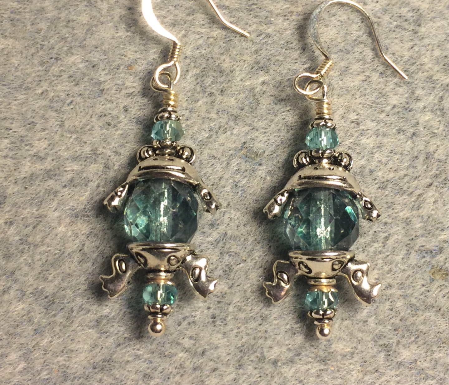 Silver frog earrings made with silver frog bead caps and large light turquoise Czech glass beads.