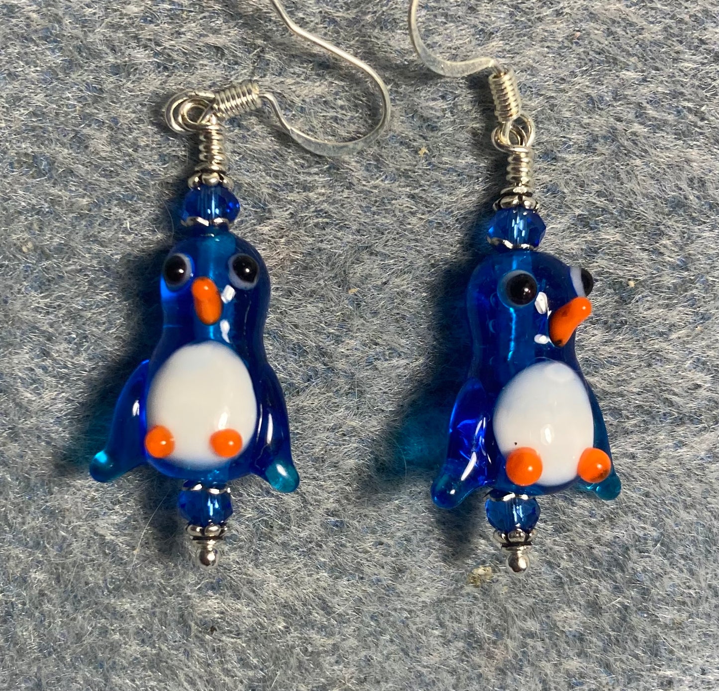 Translucent bright blue and white lamp work penguin bead earrings adorned with blue Chinese crystal beads.