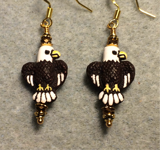 Small brown, white, and yellow ceramic flying eagle bead earrings adorned with brown gold Chinese crystal beads.