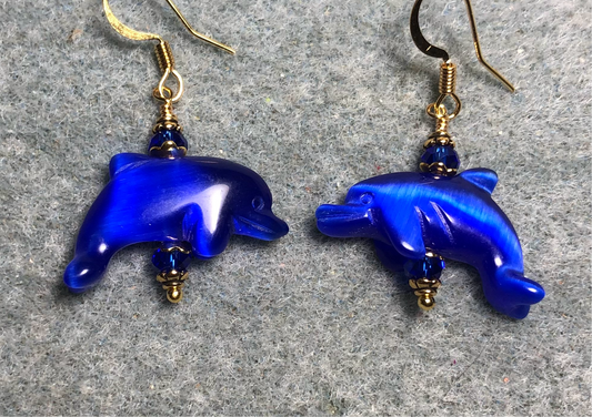 Dark blue fiber optic (cat’s eye) dolphin bead earrings adorned with dark blue Chinese crystal beads.