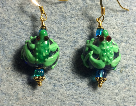 Turquoise and green lamp work frog bead earrings adorned with turquoise Czech glass beads.