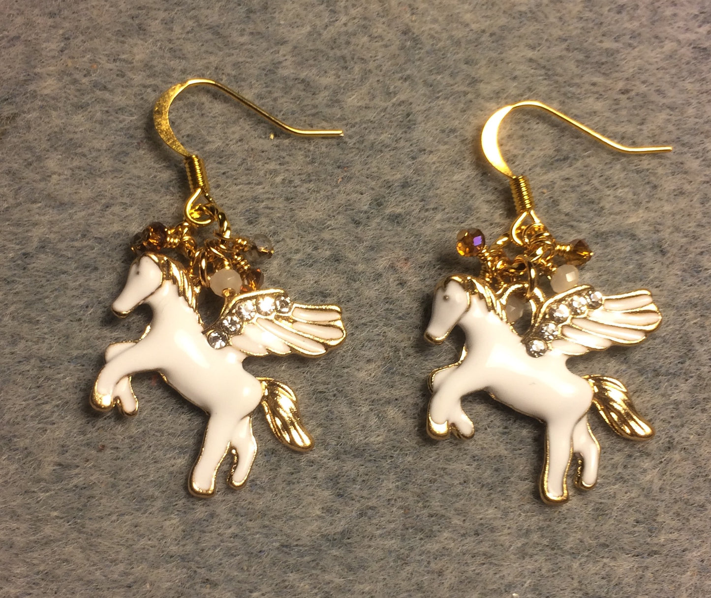 White and gold enamel and rhinestone Pegasus (flying horse) charm earrings adorned with tiny dangling white and amber Chinese crystal beads.