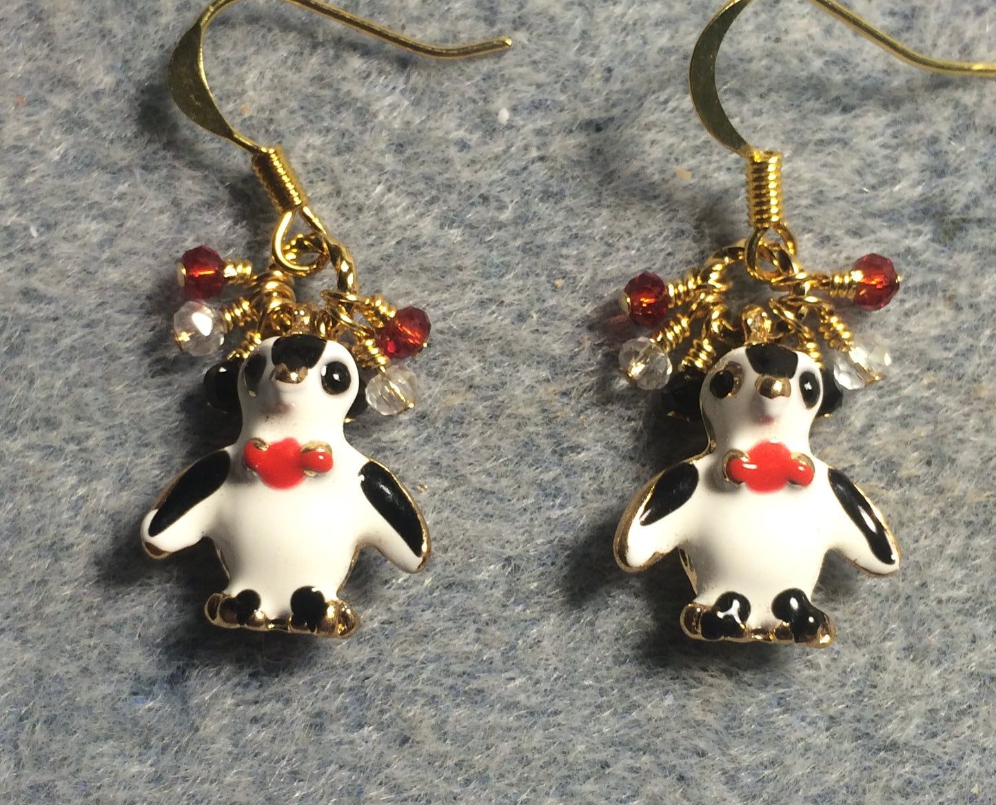 Black, white, and red enamel penguin charm earrings adorned with tiny dangling black, clear, and red Chinese crystal beads.