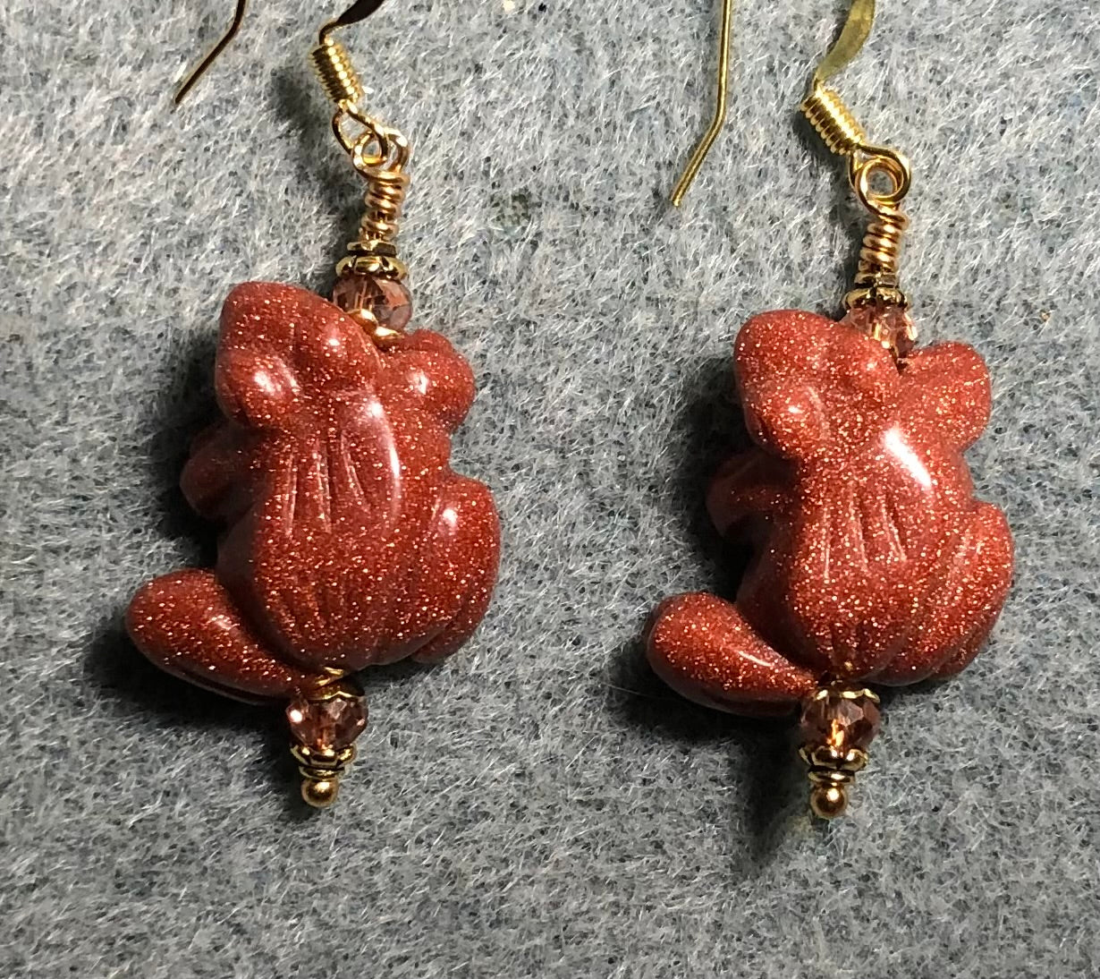 Orange goldstone gemstone frog bead earrings adorned with orange Chinese crystal beads.