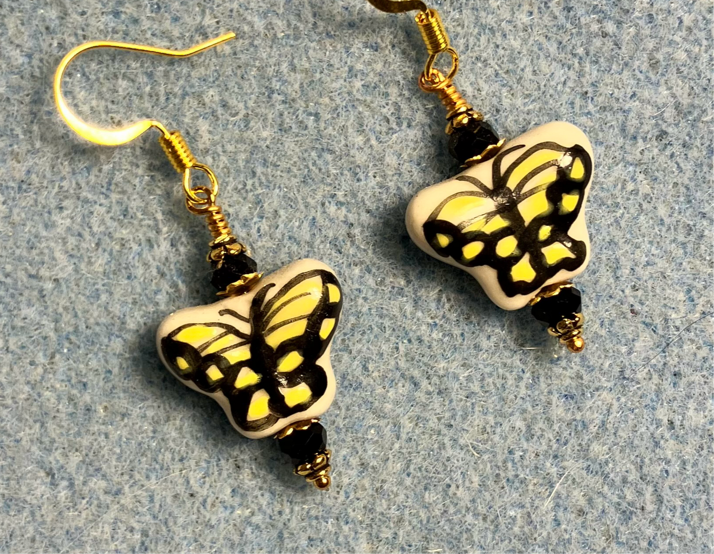 Yellow and black ceramic Monarch butterfly bead earrings adorned with black Chinese crystal beads.