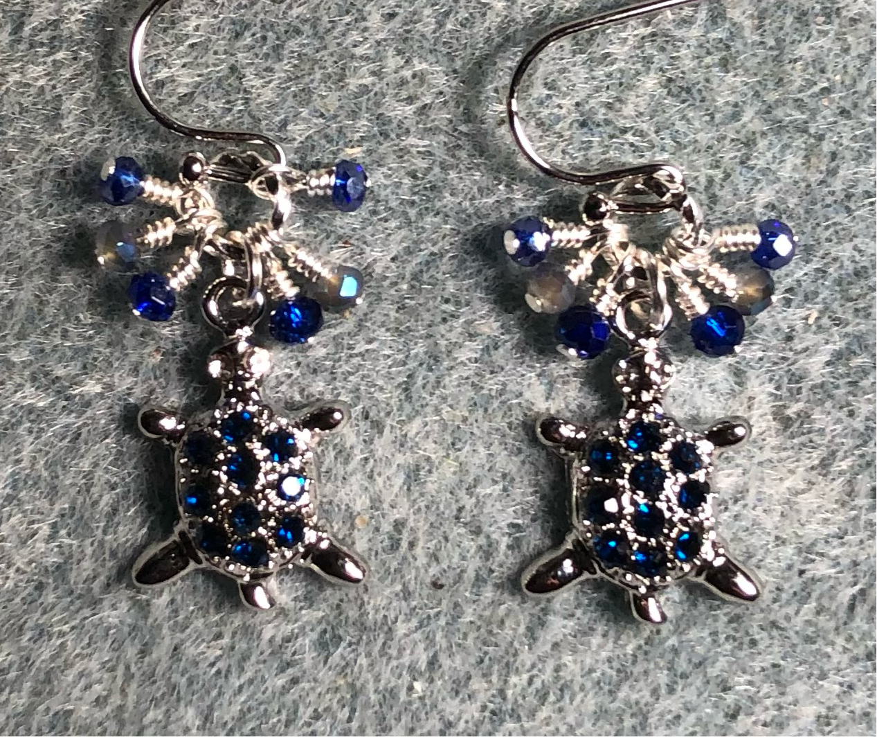 Silver and dark blue rhinestone turtle charm earrings adorned with tiny dangling dark blue and gray Chinese crystal beads.