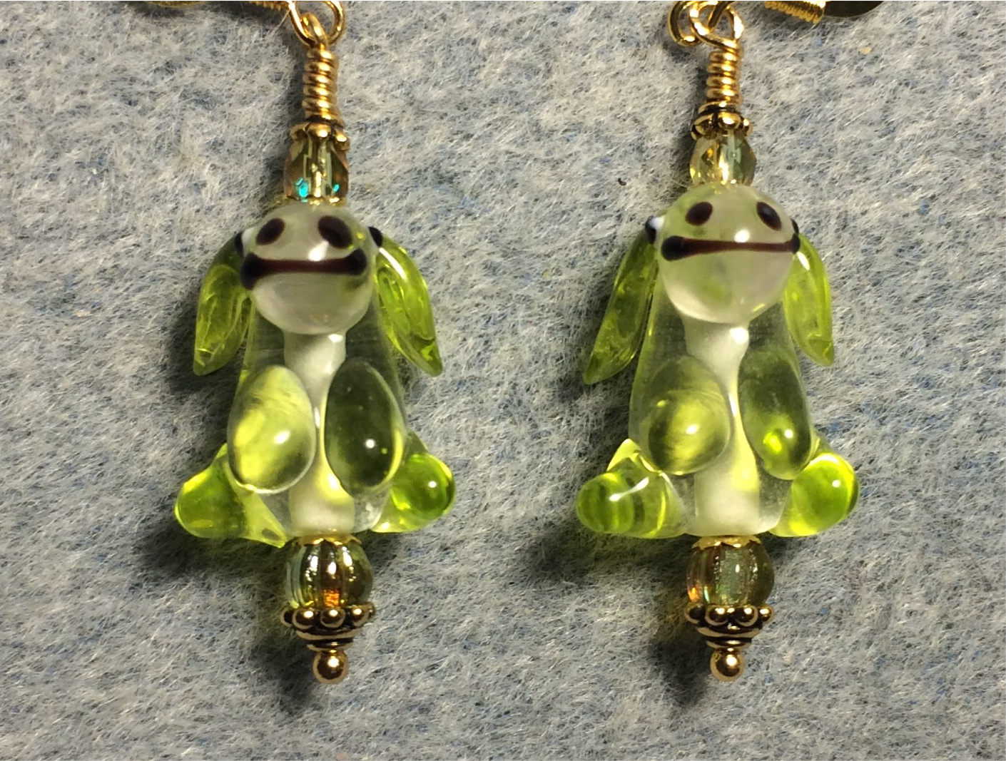 Lime green and clear lamp work puppy dog bead earrings adorned with lime green Czech glass beads.