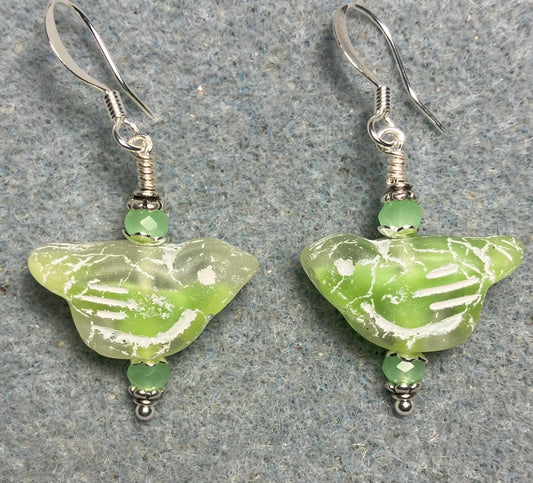 Light green (with white inlay) Czech glass bird bead earrings adorned with light green Chinese crystal beads.