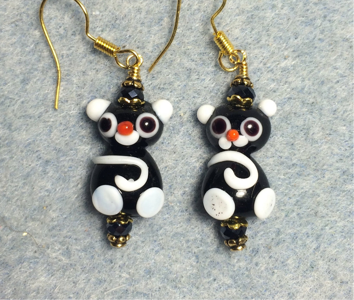 Small black and white lamp work cat bead earrings adorned with black Chinese crystal beads.