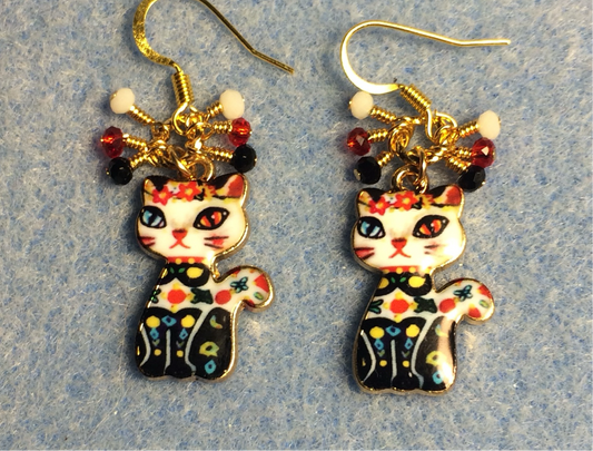 Black, white, and red enamel cat charm earrings adorned with tiny dangling black, white, and red Chinese crystal beads.