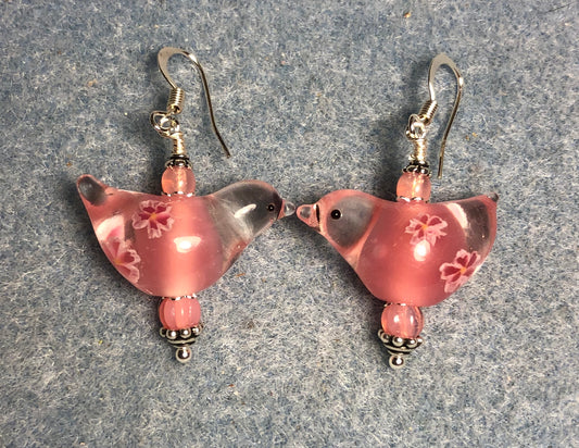 Translucent pink lamp work songbird bead earrings adorned with pink Czech glass beads.