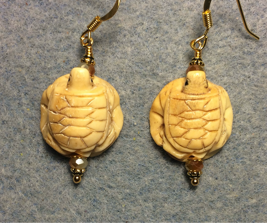 Carved bone turtle on a lily pad bead earrings adorned with beige Chinese crystal beads.