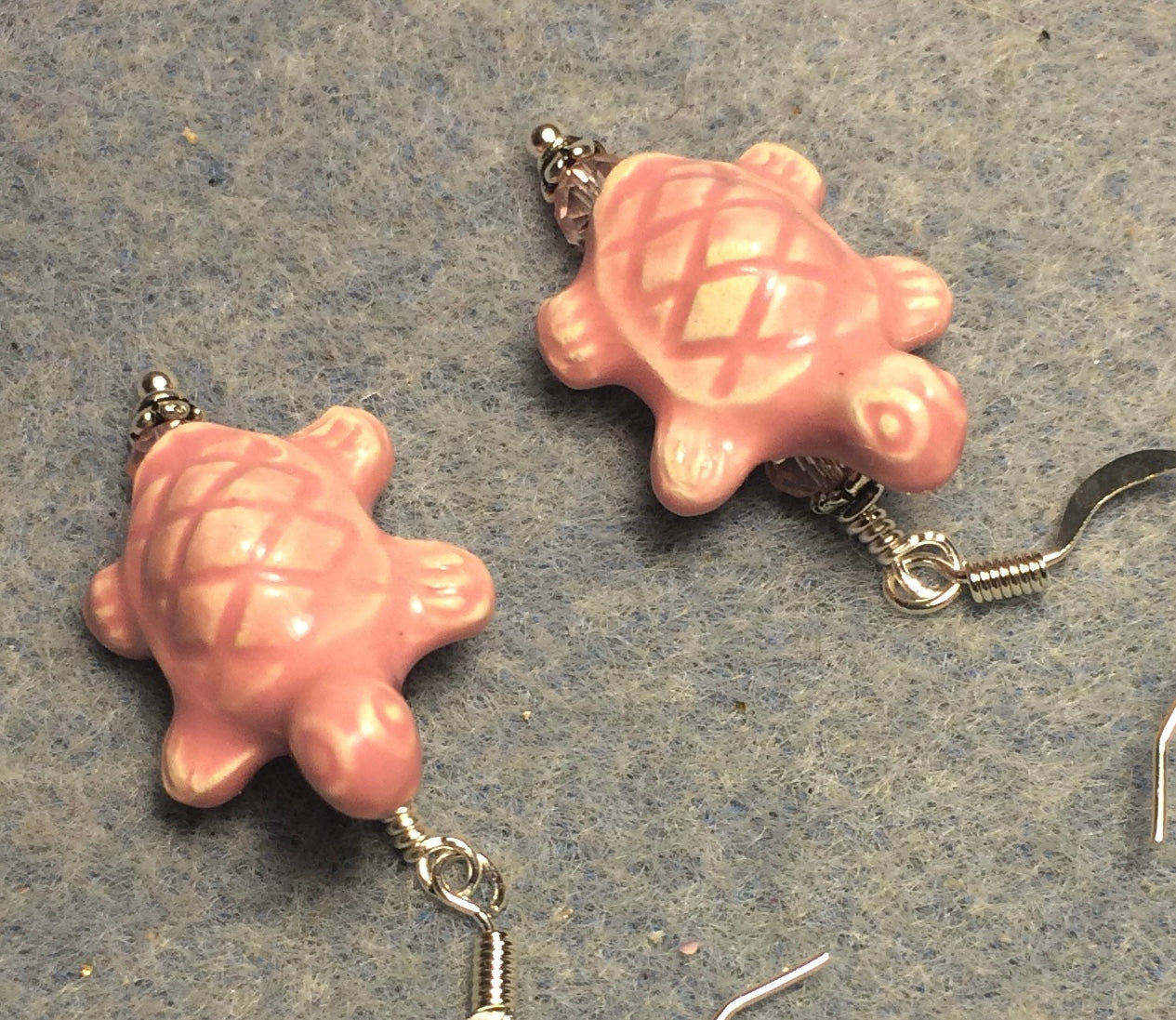 Pink ceramic turtle bead earrings adorned with pink Chinese crystal beads.