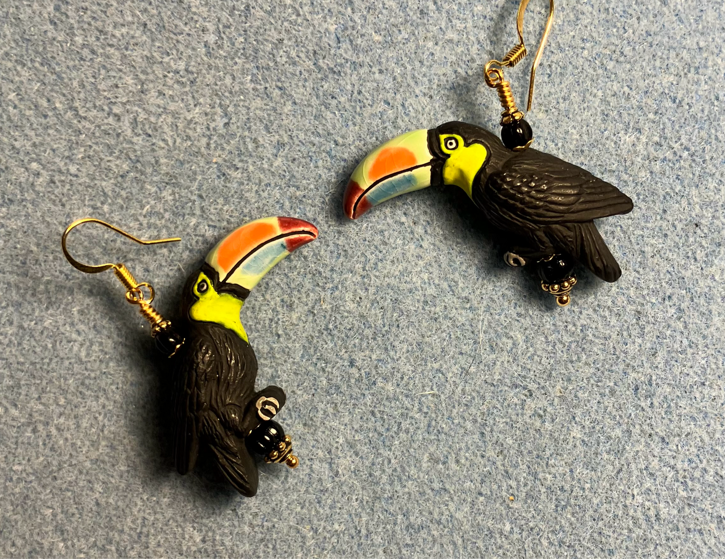 Large black (with colorful beaks) ceramic toucan bead earrings adorned with black Czech glass beads.