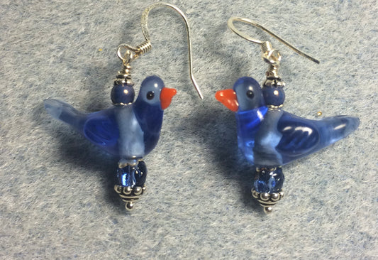 Translucent blue lamp work songbird bead earrings adorned with blue Czech glass beads.