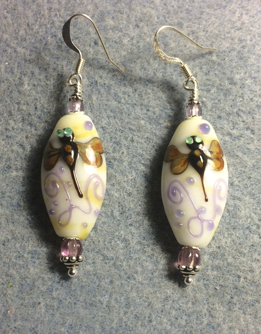 Off white, tan, and violet lamp work dragonfly bead earrings adorned with violet Czech glass beads.