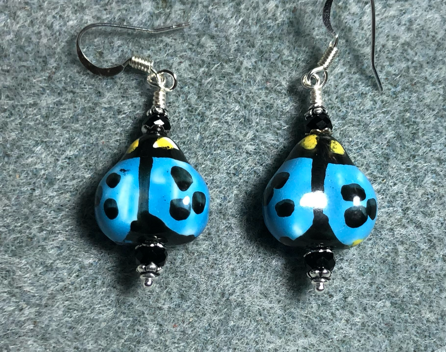 Blue and black ceramic ladybug bead earrings adorned with black Chinese crystal beads.