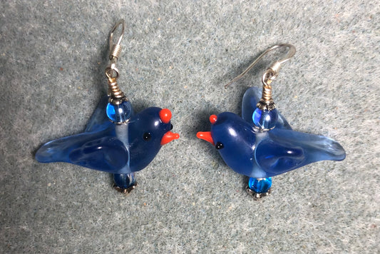 Translucent blue lamp work flying bird bead earrings adorned with blue Czech glass beads.