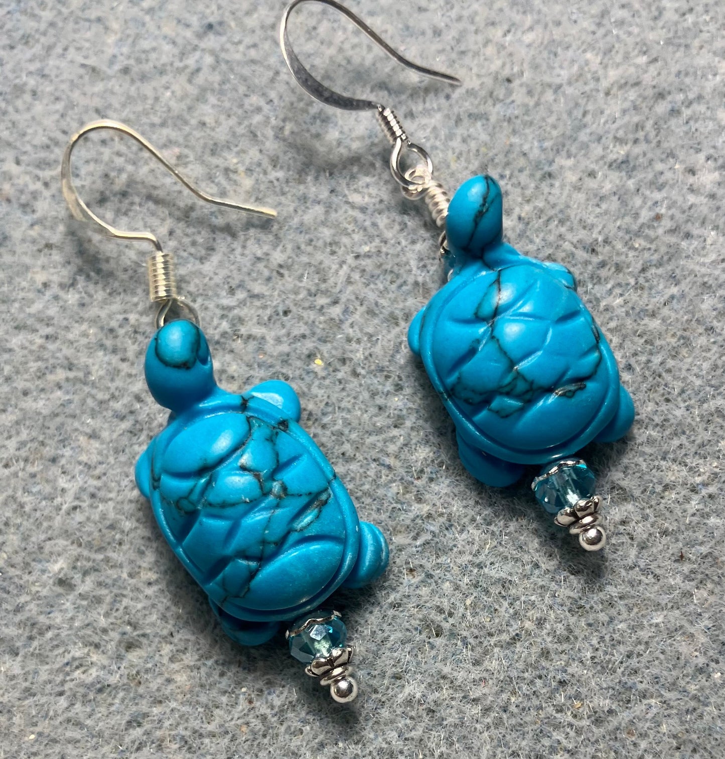 Turquoise howlite gemstone turtle bead earrings adorned with turquoise Chinese crystal beads.