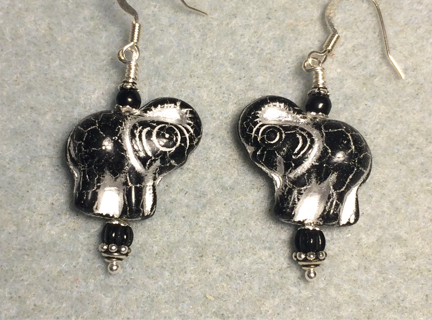 Opaque black (with silver inlay) Czech glass elephant bead earrings adorned with black Czech glass beads.