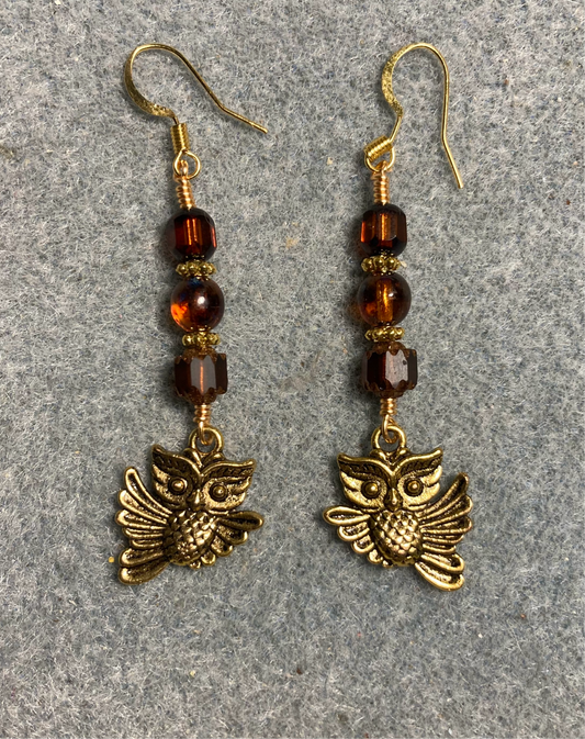 Gold owl charm earrings adorned with brown Czech glass melon beads.