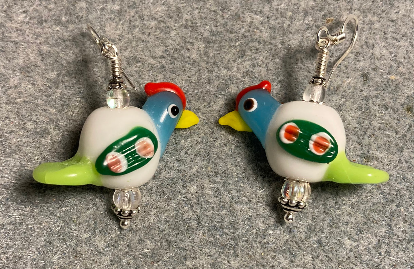 White, turquoise, and green lamp work chicken bead earrings adorned with clear Czech glass beads.