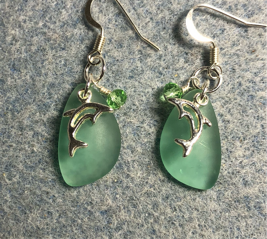 Small light green sea glass pendant bead earrings adorned with small silver dolphin charms and light green Chinese crystal beads.