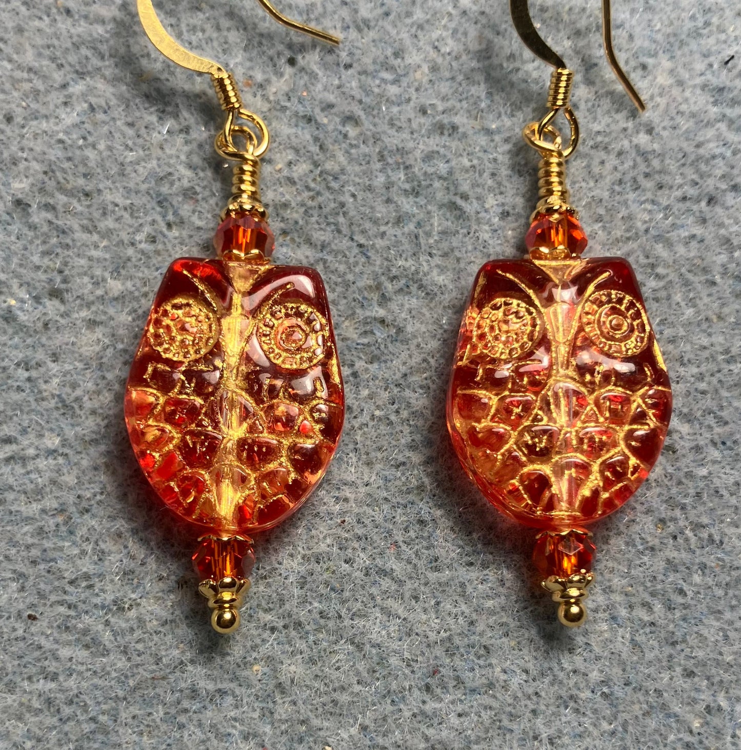 Sparkly orange (with gold wash) Czech glass owl bead earrings adorned with orange Chinese crystal beads.