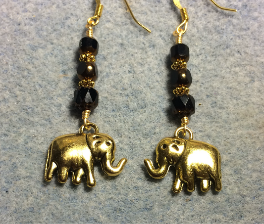 Large gold elephant charm earrings adorned with black Czech glass beads.