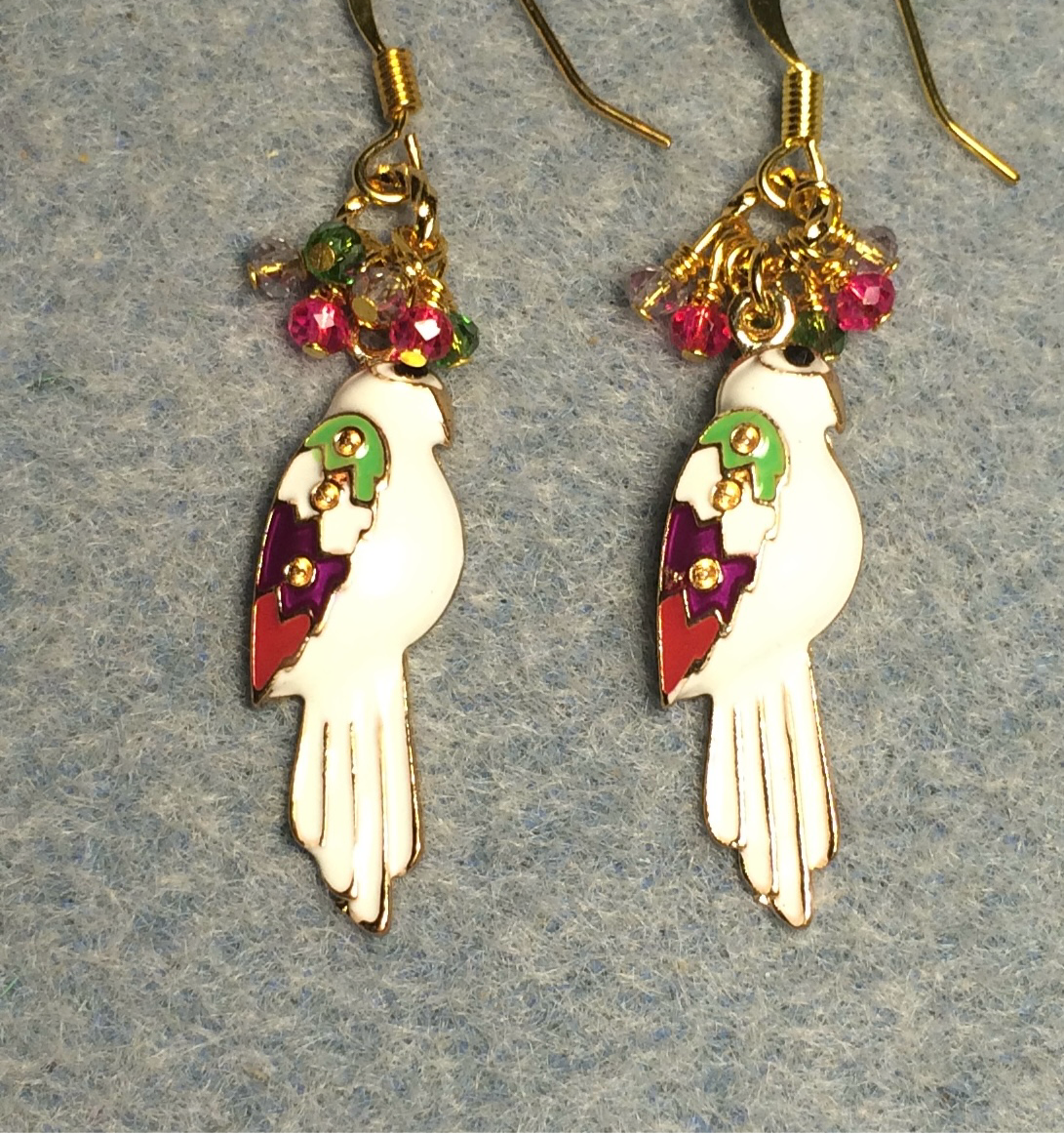 White enamel parrot charm earrings adorned with tiny dangling hot pink and green Chinese crystal beads.