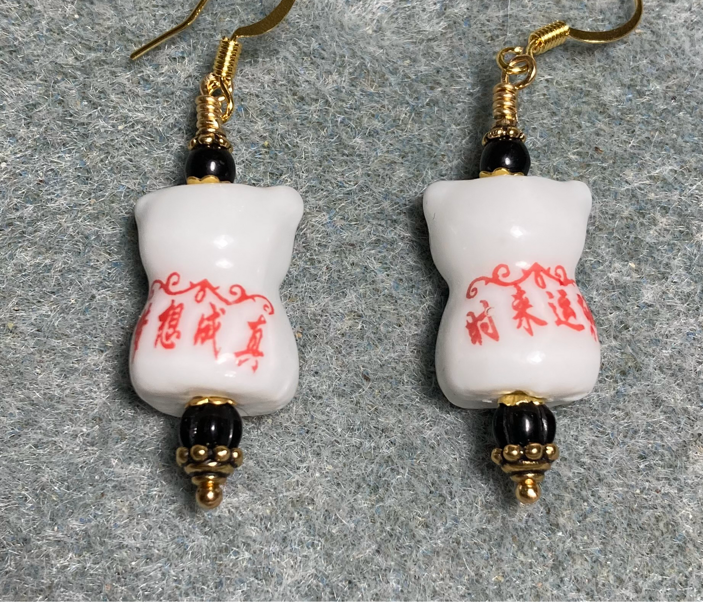 White, black, and red ceramic  cat bead earrings adorned with black Czech glass beads.