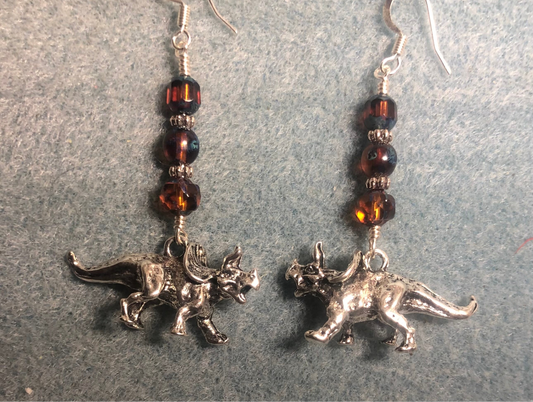 Large silver Triceratops dinosaur charm earrings adorned with brown Czech glass beads