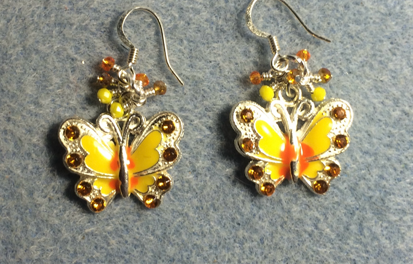 Yellow and orange enamel and rhinestone butterfly charm earrings adorned with tiny dangling yellow and orange Chinese crystal beads.