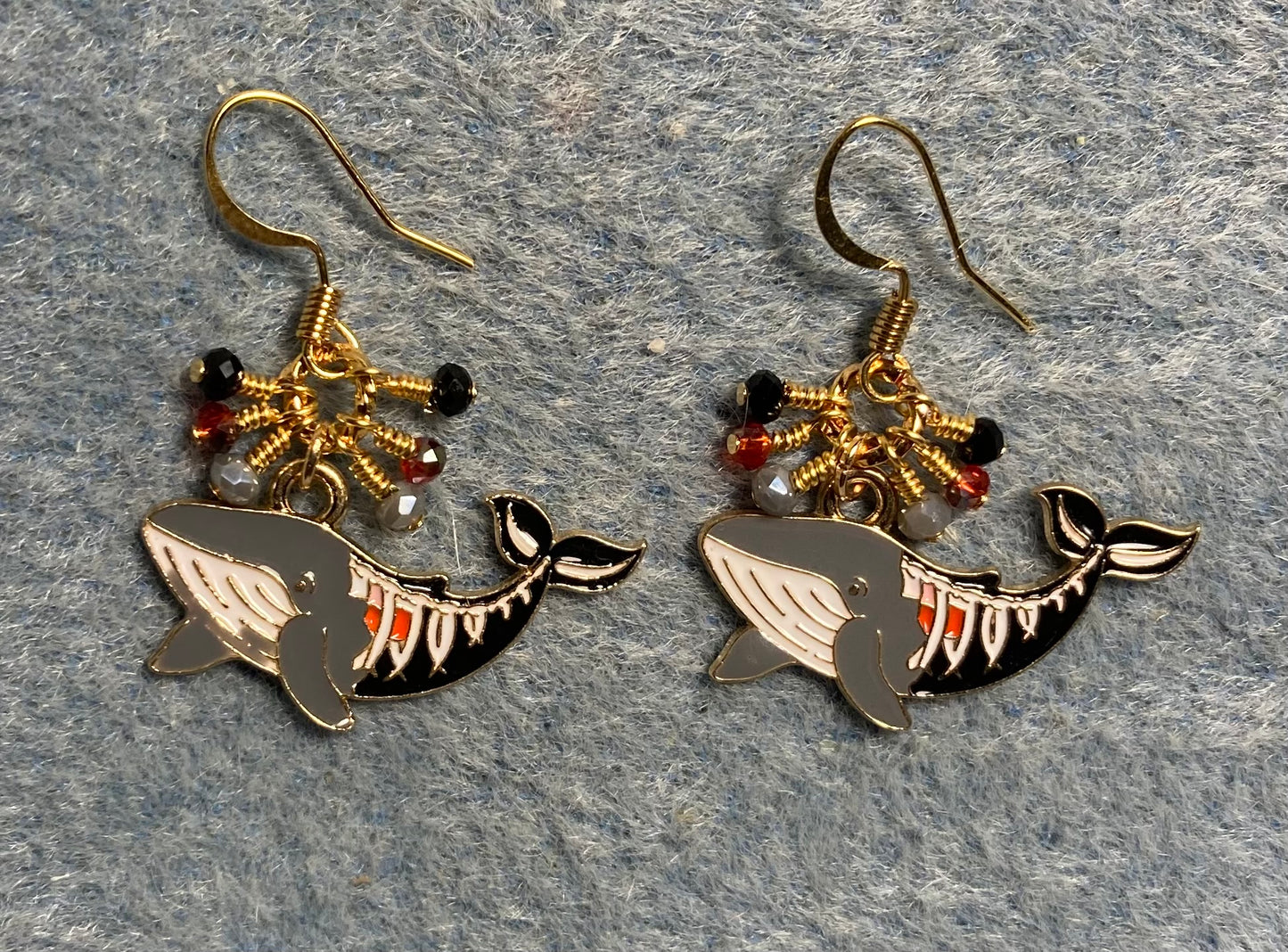 Gray, black, and red enamel shark charm earrings adorned with tiny dangling gray, black, and red Chinese crystal beads.