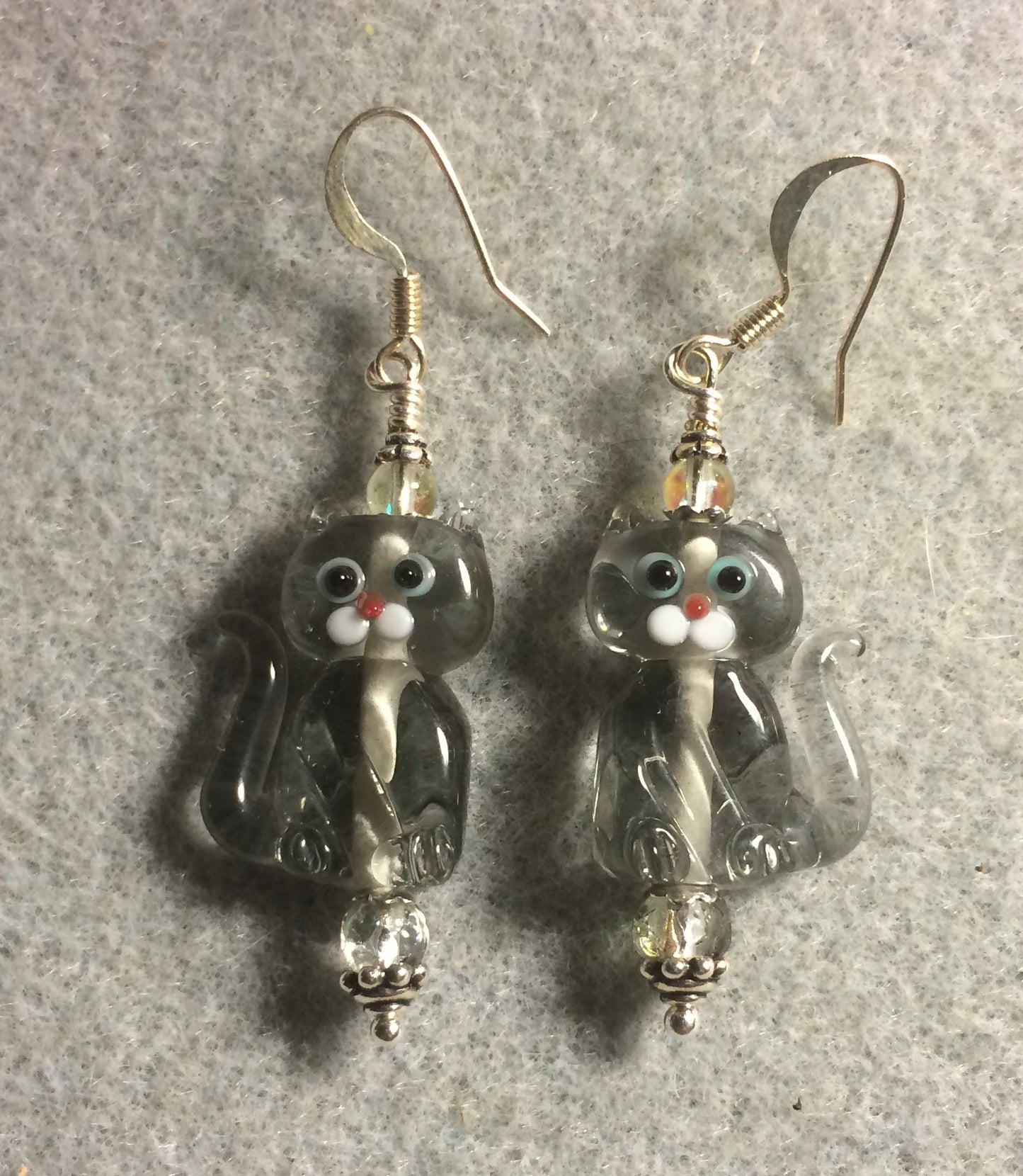 Translucent gray lamp work cat bead earrings adorned with olive clear Czech glass beads.