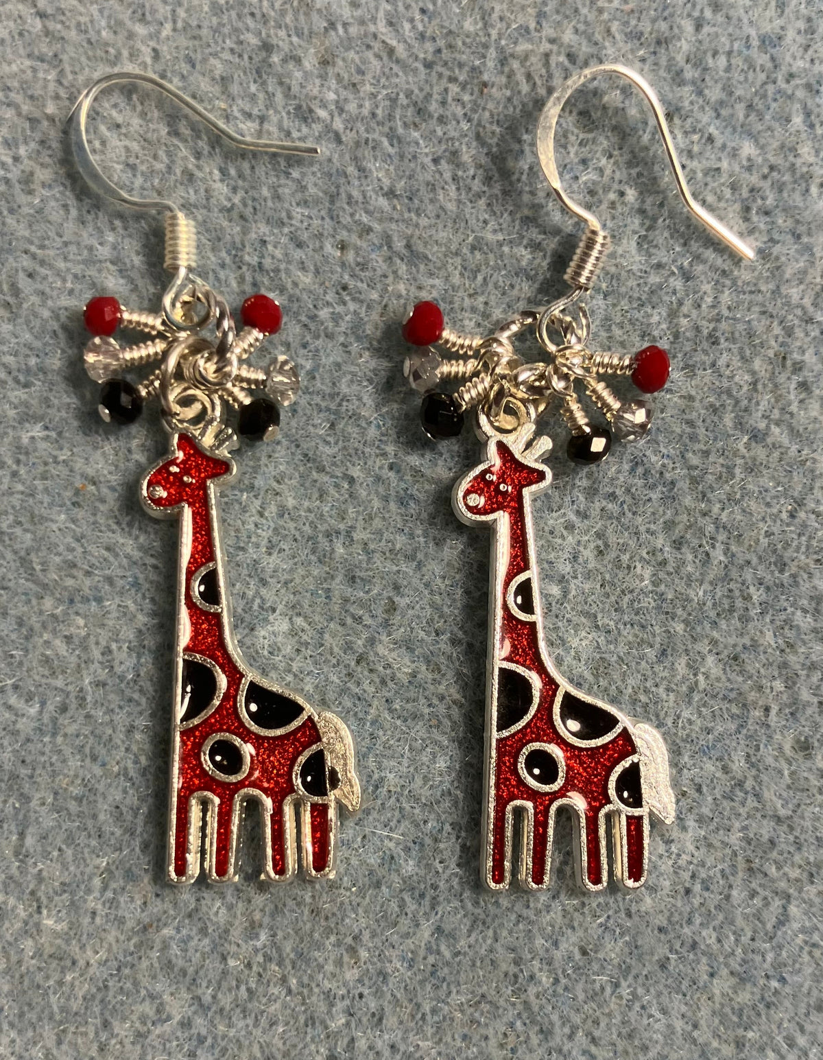 Red and black enamel spotted giraffe charm earrings adorned with tiny dangling red, clear, and black Chinese crystal beads.