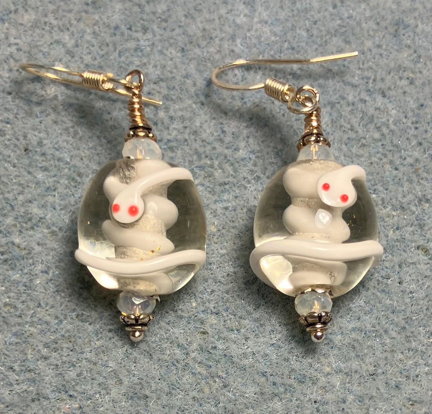 Clear and white lamp work snake bead earrings adorned with white Chinese crystal beads.
