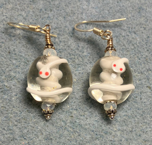 Clear and white lamp work snake bead earrings adorned with white Chinese crystal beads.